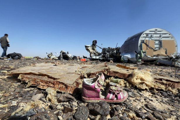A child's shoe is seen in front of debris from a Russian airliner